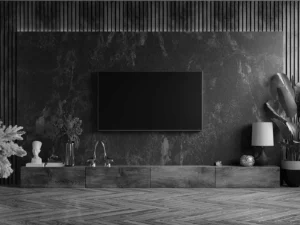 a living room with a large flat screen mounted on a marble wall with a beautiful decoration around it
