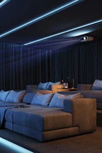 a home theater room with a couch and a projector and a projection screen