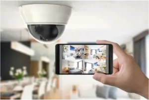 A security camera, mounted on the ceiling of a house, is pointed towards the room.