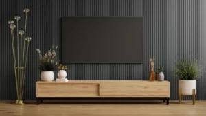 A flat-screen TV mounted on a black wall above a wooden entertainment center in a living room.